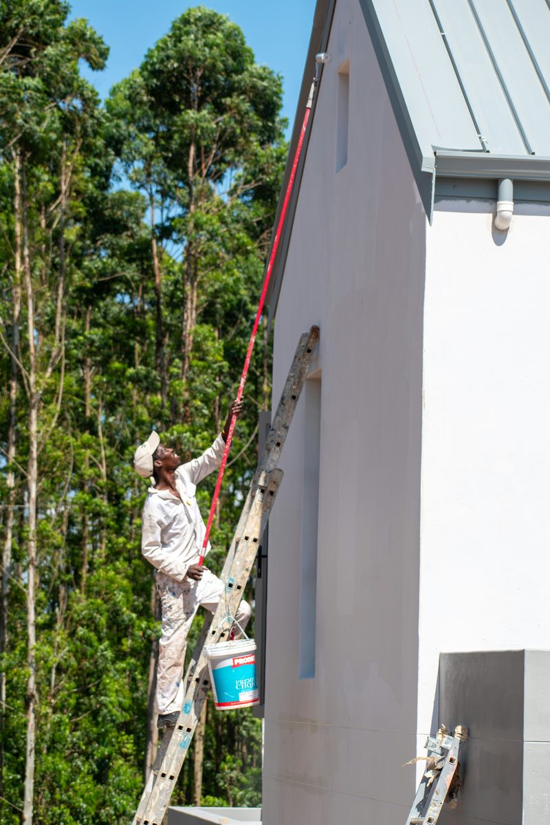 Professional painter at work on a home exterior